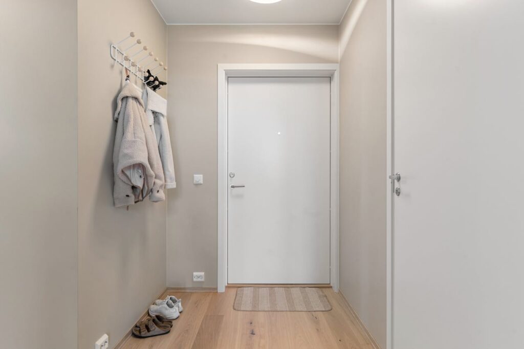 zipwp-image-19866475 A hallway with a coat rack and a door